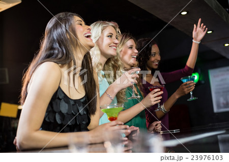 Happy friends having a drink Happy friends having a drink 23976103