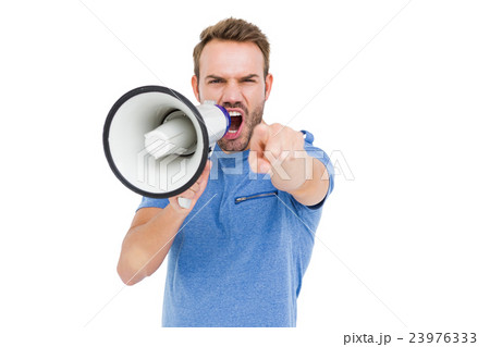 Young man shouting on horn loudspeaker 23976333