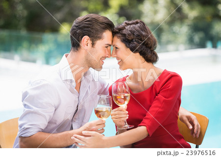 Romantic couple holding white wine 23976516
