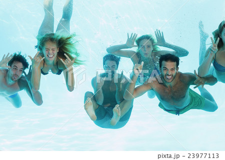 Group of young friends underwater Group of young friends underwater 23977113