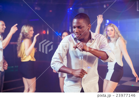 Happy friends dancing cheerfully 23977146