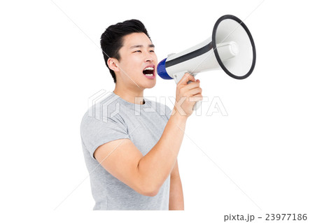 Young man shouting on horn loudspeaker 23977186
