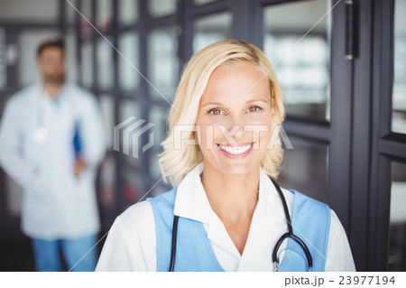 Portrait of cheerful female doctor 23977194