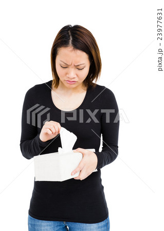 Woman taking a tissue from tissue box 23977631
