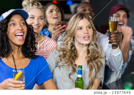 Happy friends watching sport 23977649