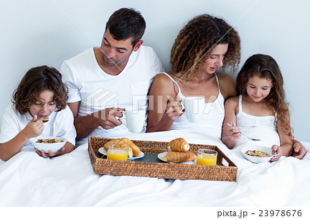 Family having breakfast in bed Family having breakfast in bed 23978676