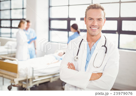 Portrait of doctor standing with arms crossed Portrait of doctor standing with arms crossed 23979076