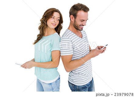 Woman looking at mans mobile phone Woman looking at mans mobile phone 23979078