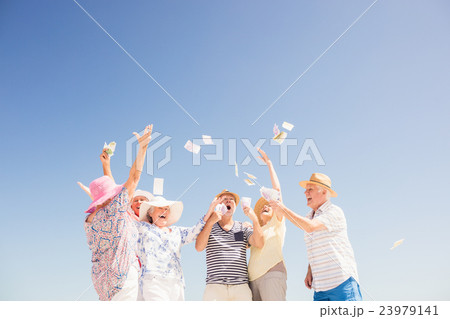 Happy senior throwing money 23979141