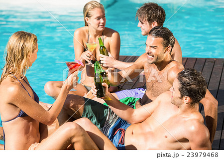 Happy friends enjoying at the swimming pool 23979468