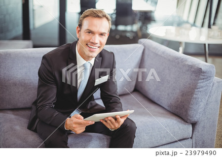 Happy businessman using digital tablet Happy businessman using digital tablet 23979490