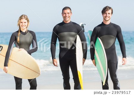 Portrait of surfer friends with surfboard standing on the beach 23979517