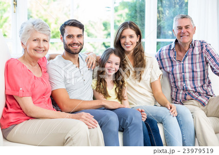 Portrait of happy family sitting on sofa 23979519