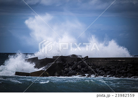 Stone breakwater with breaking waves. Stone breakwater with breaking waves. 23982559