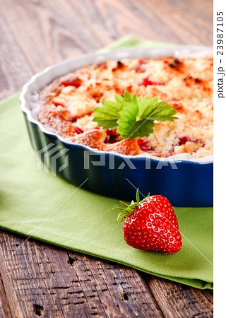 Single harvested strawberry in front of fruit Single harvested strawberry in front of fruit 23987105