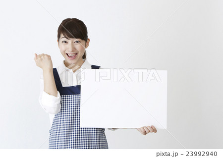 メッセージボードを持つエプロン姿の女性 メッセージボードを持つエプロン姿の女性 23992940