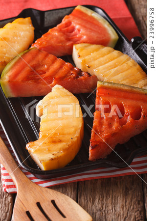 Sliced watermelon and melon in a pan grill closeup 23996758