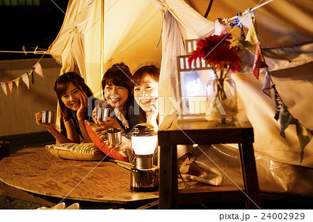 キャンプ グランピング アウトドア テント 女性 夜 友達 友人 女子会の写真素材