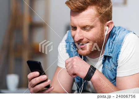 Pleasant man listening to music 24006756