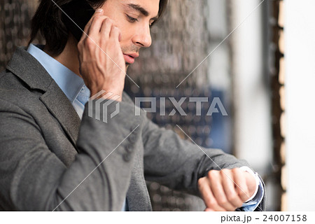 Pleasant man talking on smart phone Pleasant man talking on smart phone 24007158