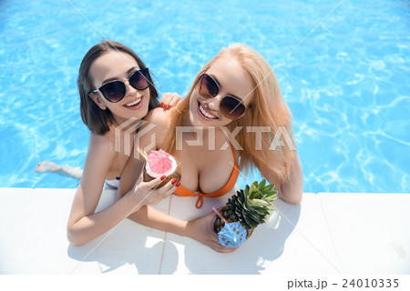 Beautiful female friends enjoying vacation 24010335