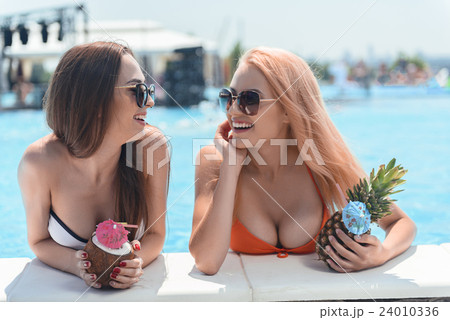 Cheerful young women relaxing in water with 24010336