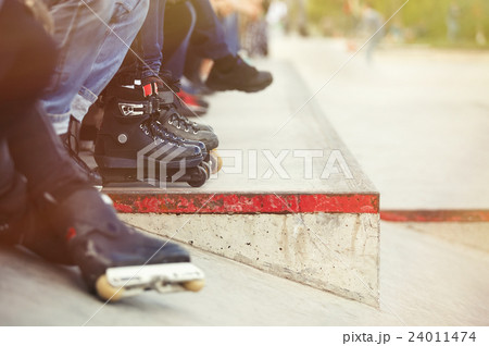 Aggressive inline rollerblader sitting  24011474