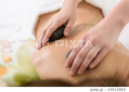 Skillful beautician pampering female body Skillful beautician pampering female body 24012663