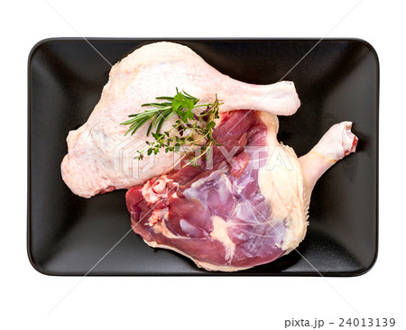Muscovy duck leg with herb on black plate Muscovy duck leg with herb on black plate 24013139