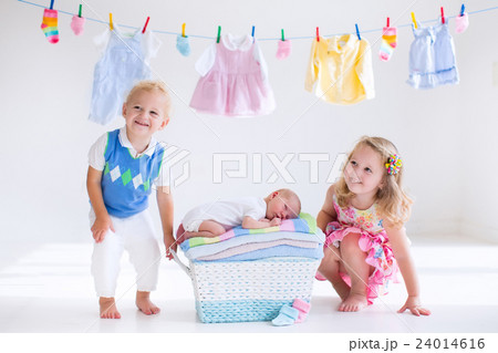 Brother and sister kissing newborn baby Brother and sister kissing newborn baby 24014616