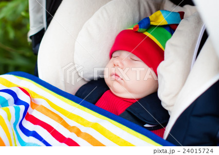 Baby sleeping in a stroller 24015724