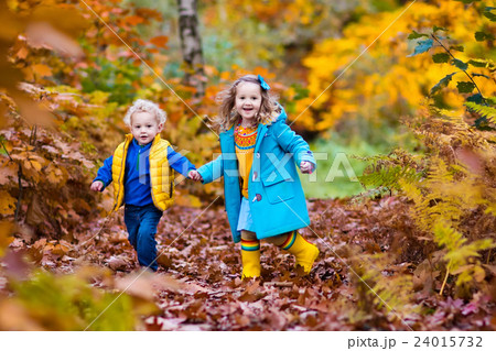 Kids playing in autumn park Kids playing in autumn park 24015732
