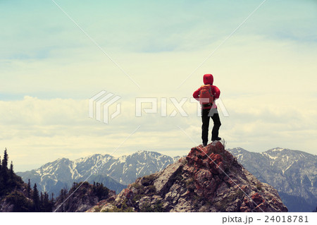 woman backpacke hiking  on mountain peak cliff 24018781