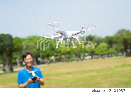 man play drone in park man play drone in park 24019374