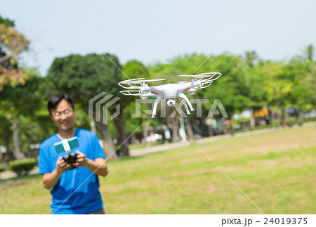 man play drone in park man play drone in park 24019375