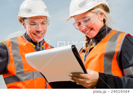 Two people working Two people working 24019384