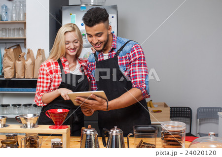 Barista coffee shop couple using tablet computer 24020120