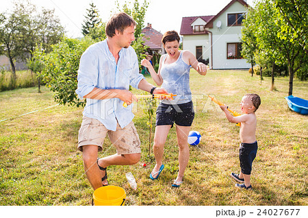 Little boy with mother and father splashing each Little boy with mother and father splashing each 24027677