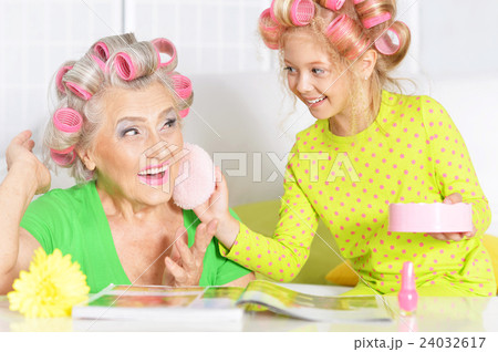 Senior woman and granddaughter doing make up Senior woman and granddaughter doing make up 24032617