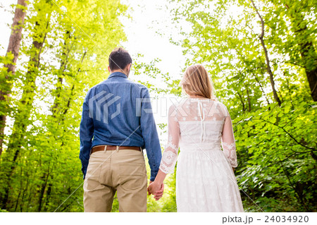 Beautiful wedding couple outside in green forest 24034920