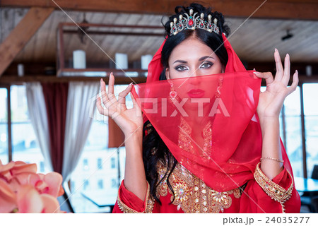 woman in red tradition dress covering the face woman in red tradition dress covering the face 24035277