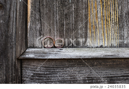 Wedding rings on a gray wooden background. Wedding rings on a gray wooden background. 24035835