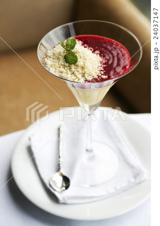 Desserts - Panna Cotta in cocktail glass on table 24037147