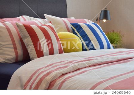 Modern bedroom with colorful pillows on beds 24039640