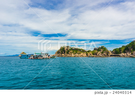 Sea with rock mountain blues sky background 24040314