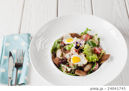 Salad with tongue on white wooden background Salad with tongue on white wooden background 24041745