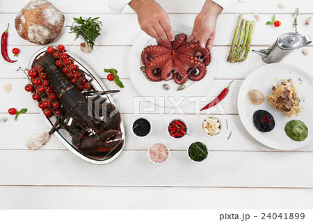 Chef cooking octopus in kitchen, flat lay Chef cooking octopus in kitchen, flat lay 24041899