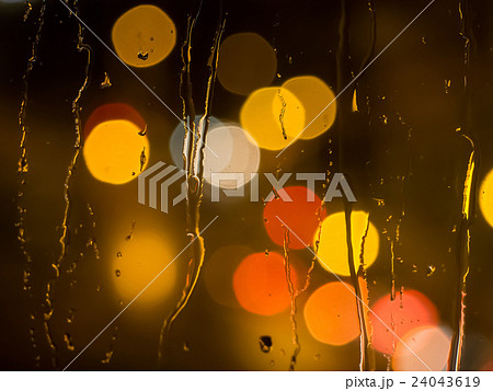 Raindrops on a window pane at night 24043619