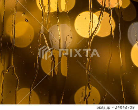 Raindrops on a window pane at night 24043708