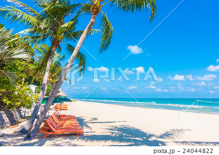 Umbrella and chair on the beach Umbrella and chair on the beach 24044822